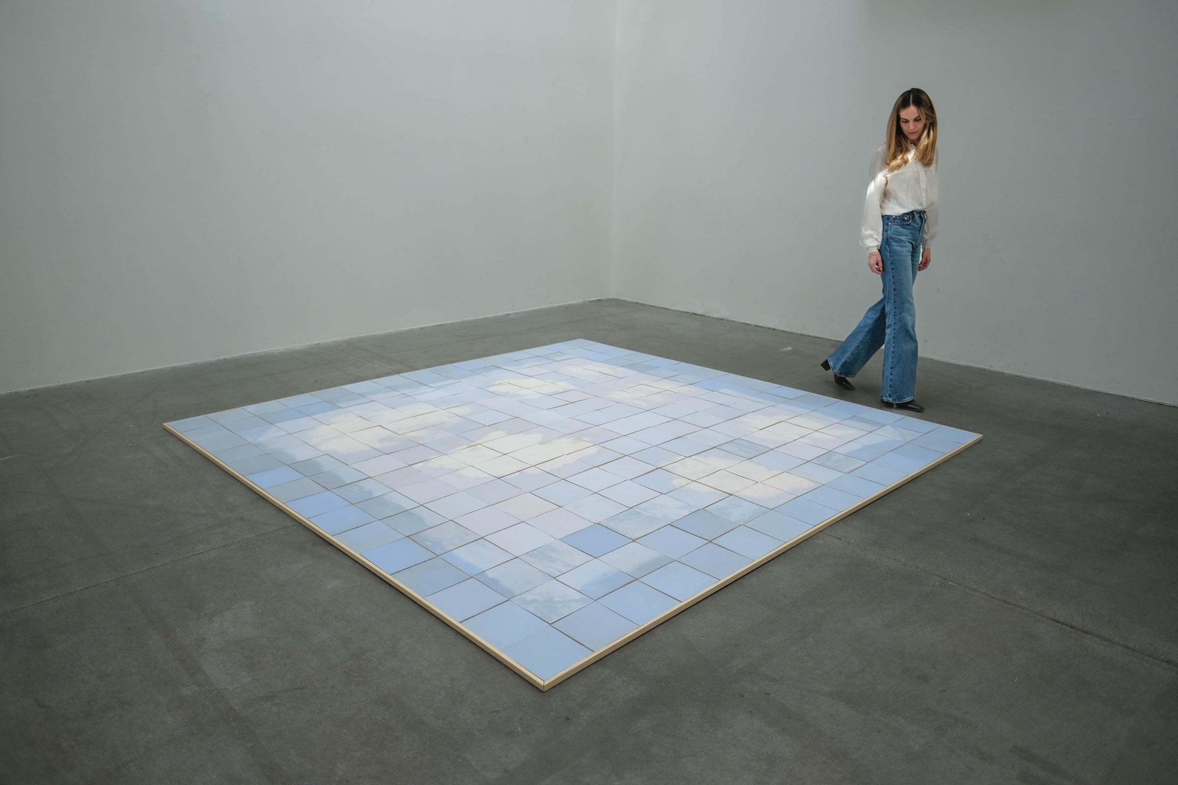 Ylva Katarina Lindh beside the ceramic floor installation As above, so below (II)